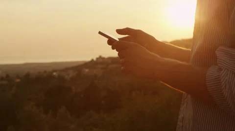 Young Man Using Phone Outdoors at Sunset Time Stock Footage