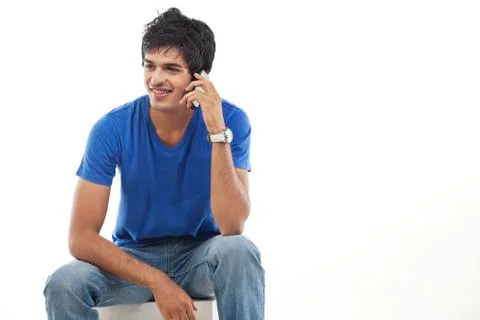 Young man using phone over white background Foto stock
