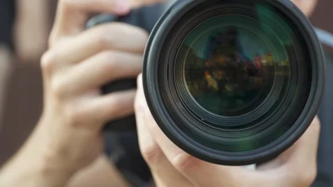 Young man using a professional camera for take pictures and videos. big zoom Stock Footage 117036485