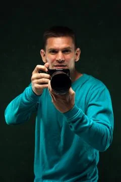 Young man using professional camera Stock Photos