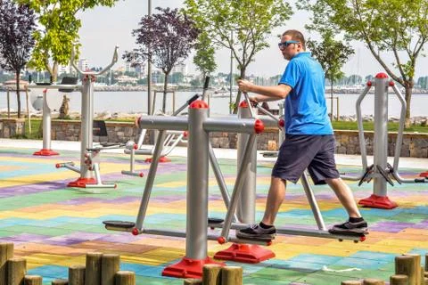Young man is using running equipment in the park with a sea background. Foto stock