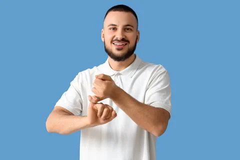 Young man using sign language on blue background Stock Photos