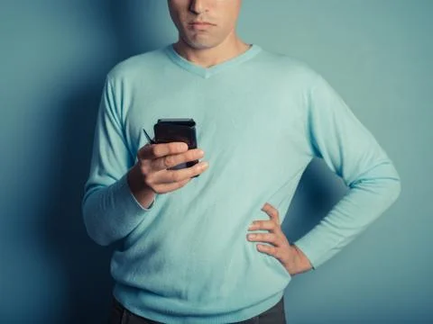 Young man using smart phone Photos