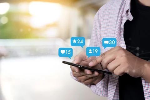 Young man using smart phone Social media and social network Marketing  concep Stock Photos
