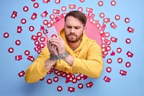 Young man using smart phone, obsessed with internet. Stock Photos