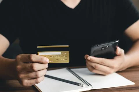 Young man using smart phone and credit card for shopping online. 스톡 사진
