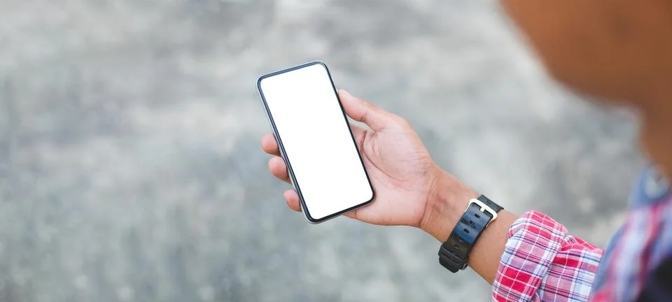 Young man using smart phone while sitting. Stock Photos