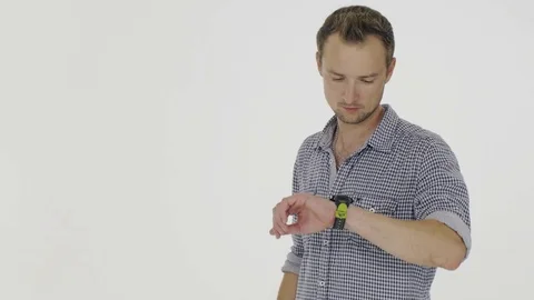 Young man using smart watches on a white background 動画素材 80354698