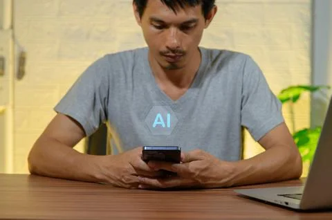 Young Man Using Smartphone with AI Concept in Modern Workspace Stock Photos