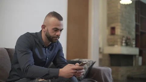 Young man using smartphone and sending email at home Stock Footage 133262677