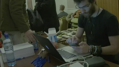 Young Man using Smartphone and Laptop at Conference Table Stock Footage 341901863