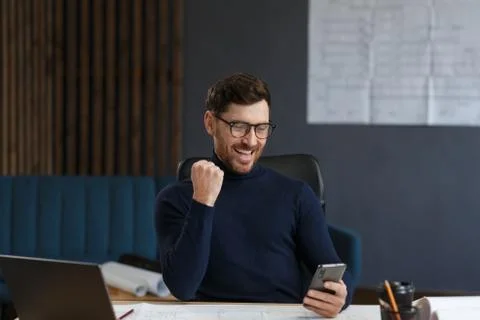Young man using smartphone and smiling. Happy businessman using mobile phone Stock Photos