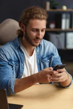 Young man using smartphone and smiling. Happy businessman using mobile phone Stock Photos