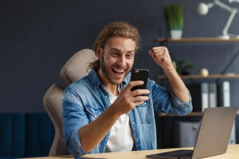 Young man using smartphone and smiling. Happy businessman using mobile phone Stock Photos