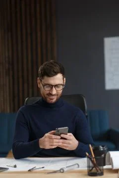 Young man using smartphone and smiling. Happy businessman using mobile phone Stock Photos