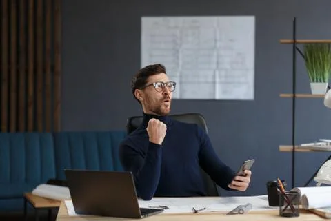 Young man using smartphone and smiling. Happy businessman using mobile phone Stock Photos