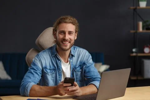 Young man using smartphone and smiling. Happy businessman using mobile phone Stock Photos