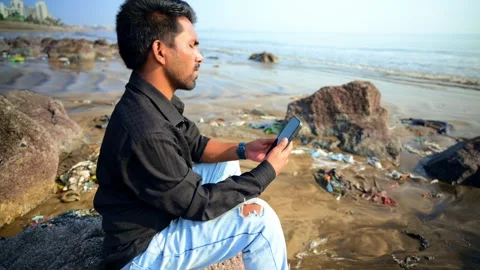 Young Man Using Smartphone on Beach Video stock 281318655
