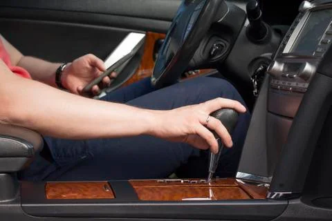 Young man using smartphone in a car Stock Photos