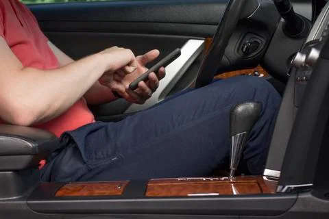 Young man using smartphone in a car Stock Photos