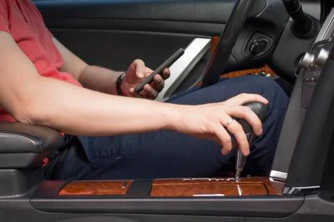 Young man using smartphone in a car Stock Photos