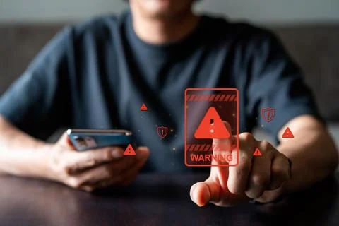 Young man using smartphone with caution warning sing for notification error Stock Photos