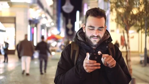 Young man using smartphone at city  landmark at night Stock Footage 73109826