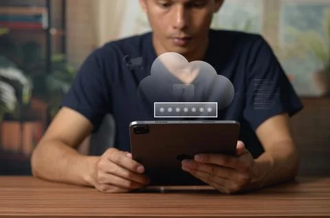 Young man using smartphone with cloud storage icon in modern indoor setting Stockfoto's