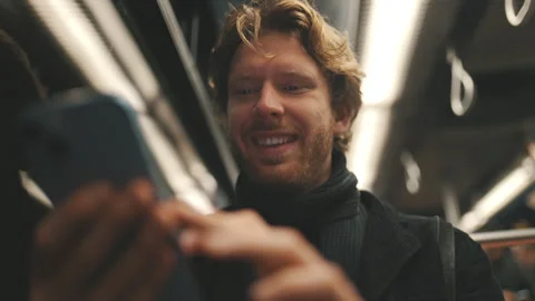 Young man using smartphone commuting on public transport Stock Footage 328960532