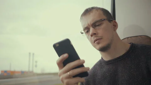Young man using smartphone during bus ride 스톡 동영상 97252843