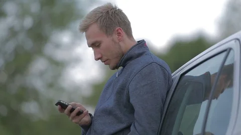 Young man using a smartphone Stock-Footage 71572786
