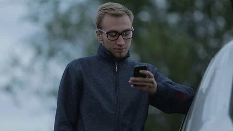 Young man using a smartphone Stock-Footage 71602333