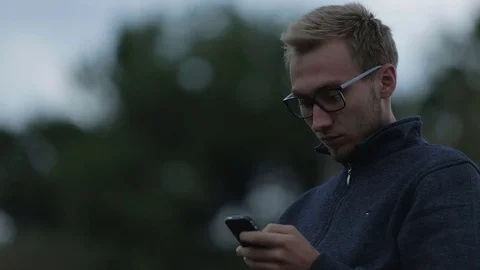Young man using a smartphone Stock-Footage 71602419