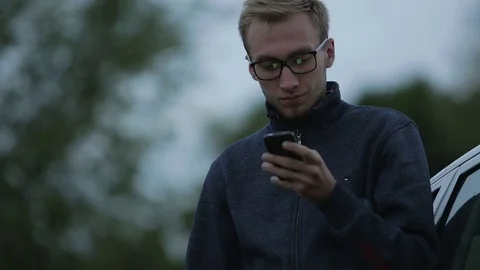 Young man using a smartphone Stock-Footage 71603356