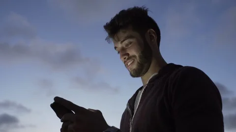 Young man using smartphone Stock Footage 106317267