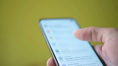 Young Man using a smartphone Google Gmail app,email surfing,business news Stock Footage 149276251