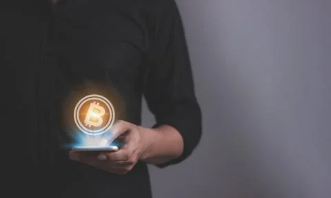 Young man using smartphone hand touching to trade cryptocurrencies online, .. Stock Photos