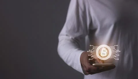 Young man using smartphone hand touching to trade cryptocurrencies online, .. Stock Photos