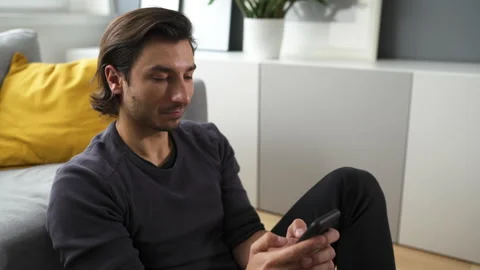 Young man using smartphone at home Stock Footage 149241851
