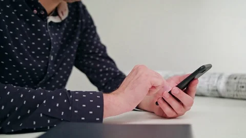 A Young Man Using a Smartphone Indoors Stock Footage 83834496
