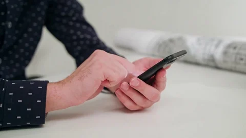 A Young Man Using a Smartphone Indoors Stock Footage 83834806