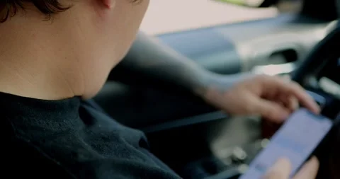 Young man using smartphone inside car. Stock Footage 313951246