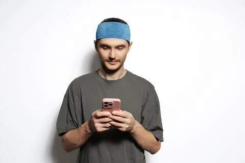Young man using smartphone isolated on white background. Stock Photos