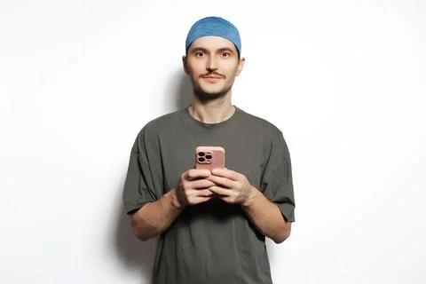 Young man using smartphone isolated on white background. Stock Photos