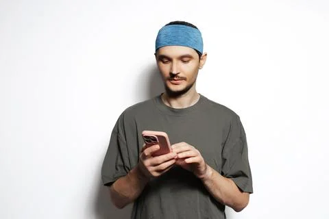 Young man using smartphone isolated on white background. Stock Photos