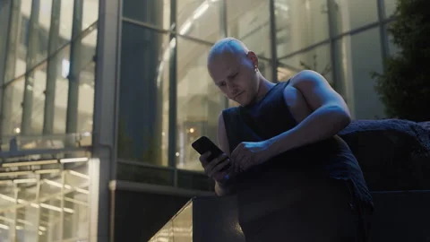 Young man using smartphone in modern city center Видео 336710679