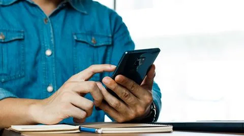 Young man is using a smartphone, online buying-selling, online business. Stock Photos
