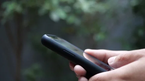 Young Man Using Smartphone on outdoor. Chat and online shopping with smart phone Stock Footage 124039626