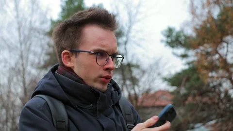 Young man using smartphone outdoors Stock Footage 302803674