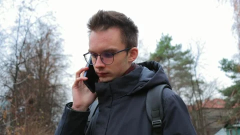 Young man using smartphone outdoors Stock Footage 302804093